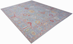 A handwoven transitional Oushak rug featuring a floral pattern in soft blue and multi-colored tones.