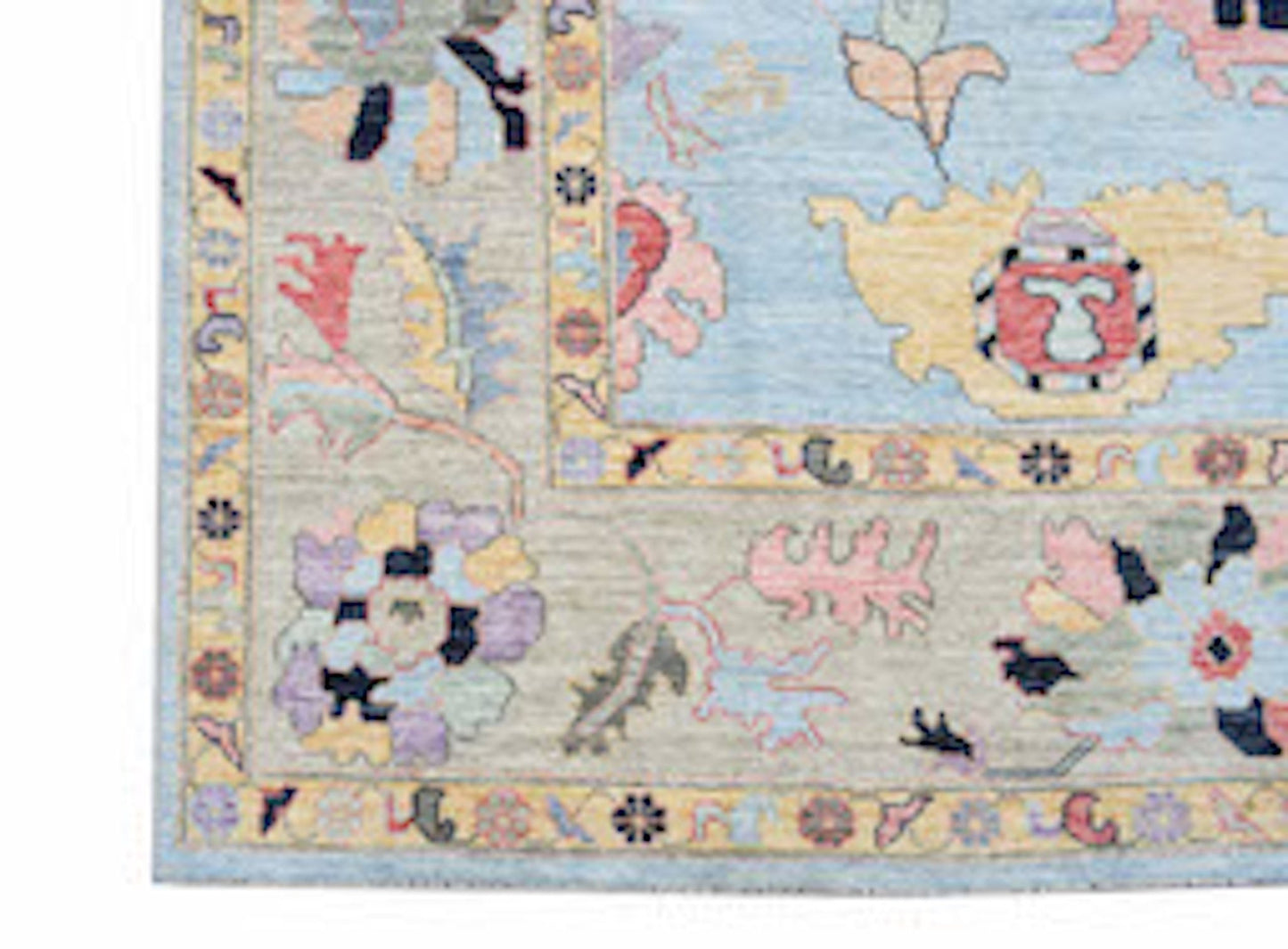 A transitional Oushak rug featuring a floral pattern in soft blue, pink, and neutral tones.