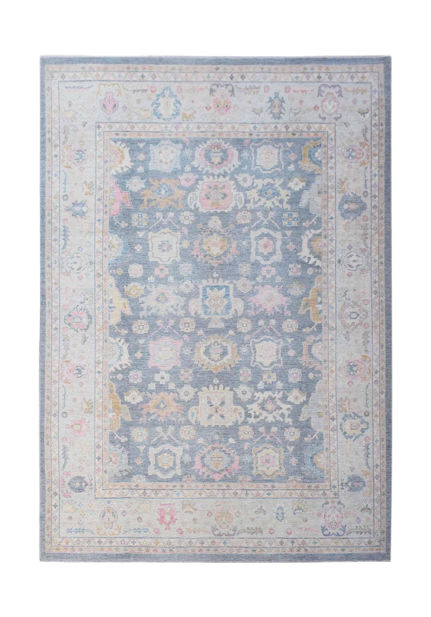 A handwoven transitional Oushak rug featuring a floral pattern in soft blue, pink, and cream tones.
