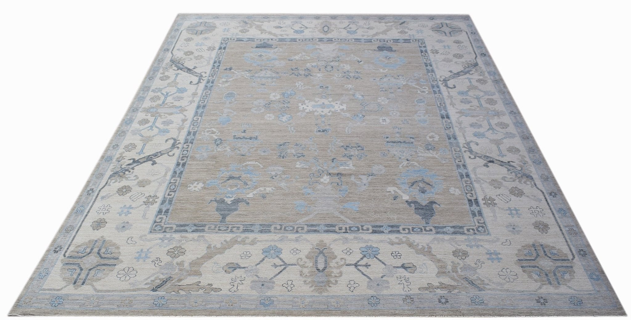 A handwoven transitional Oushak rug featuring a floral pattern in shades of blue and beige.