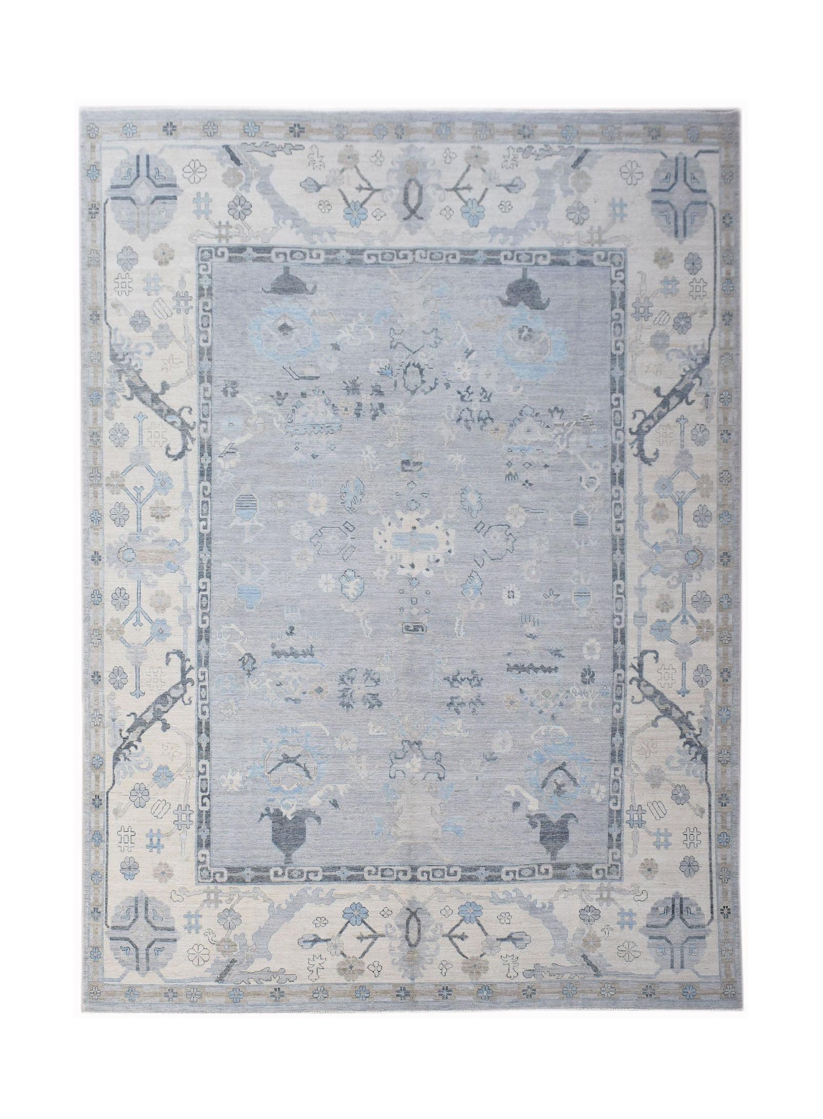 A handwoven transitional Oushak rug featuring a light blue floral pattern on a cream background.
