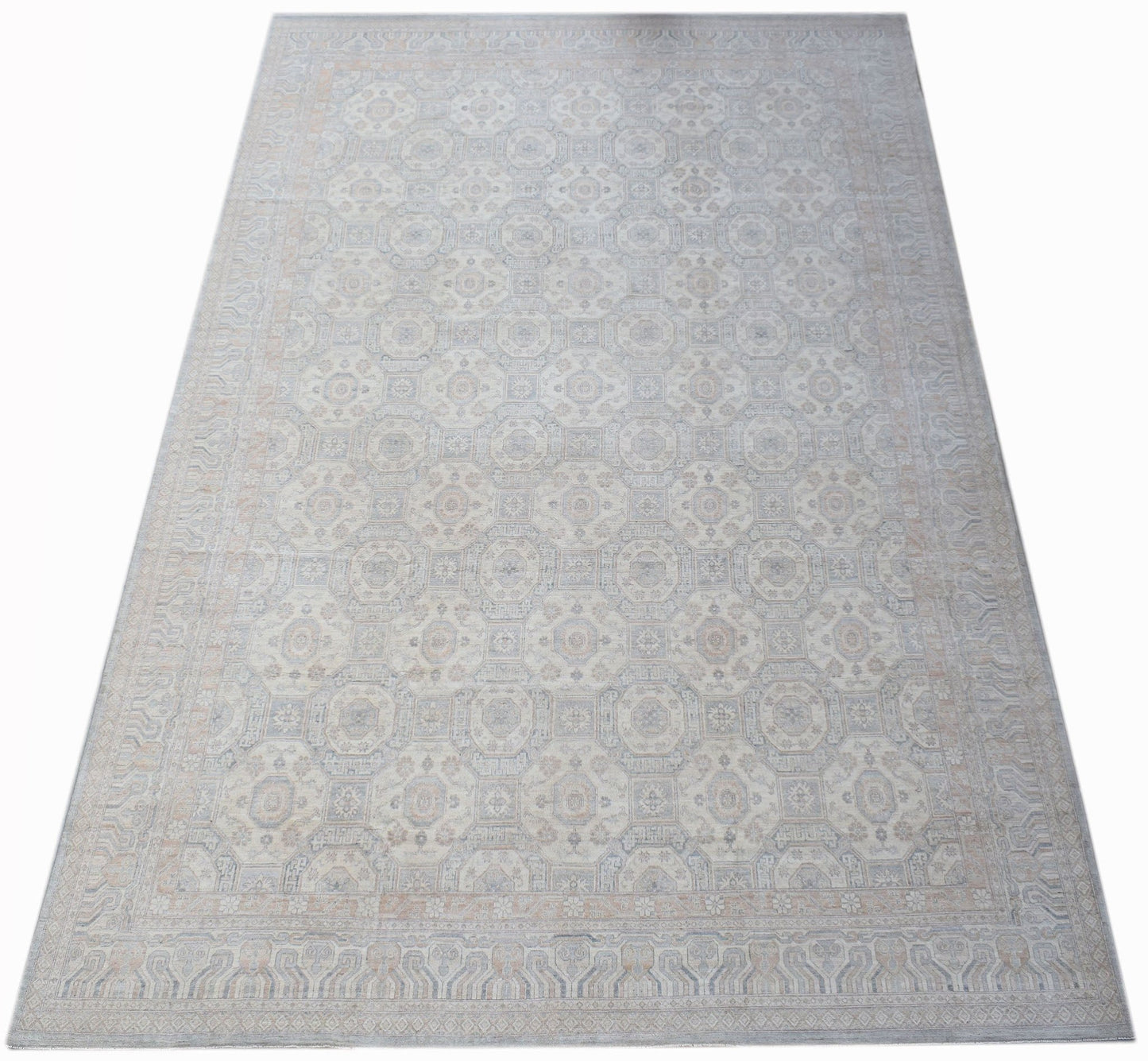A handwoven transitional Oushak rug featuring a repeating floral pattern in soft neutral tones.