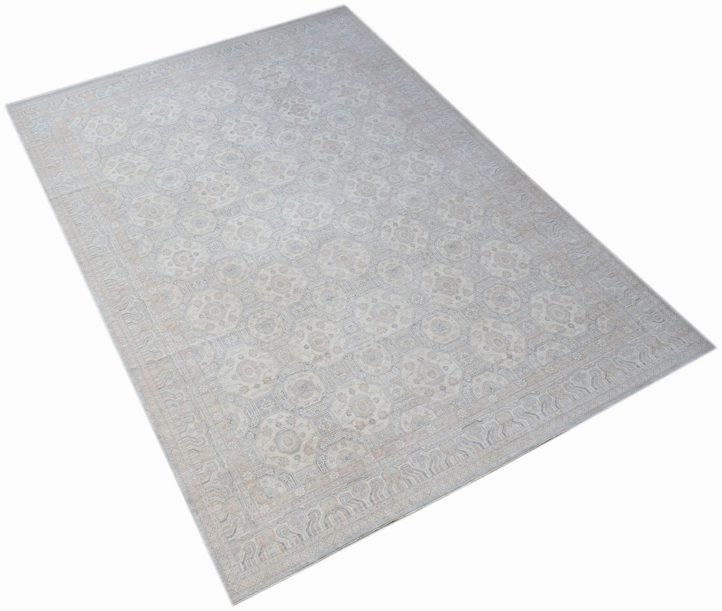 A handwoven transitional Oushak rug featuring a light floral pattern in soft neutral tones.