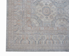 A handwoven transitional Oushak rug featuring a floral pattern in soft blue and beige tones.