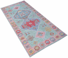 A handwoven transitional Oushak runner featuring a light blue field with geometric floral motifs.