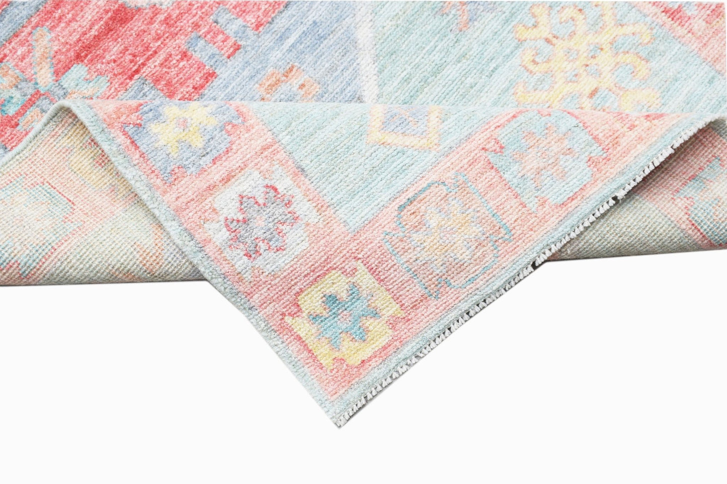 A handwoven transitional Oushak runner featuring a floral pattern in soft pastel tones.