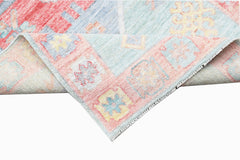 A handwoven transitional Oushak runner featuring a floral pattern in soft pastel tones.