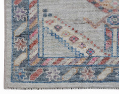 A handwoven transitional Oushak runner featuring a floral pattern in soft, muted colors.