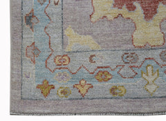 A handwoven transitional Oushak runner featuring a floral pattern in soft pastel tones.
