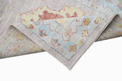 A handwoven transitional Oushak runner featuring a floral pattern in soft pastel tones.
