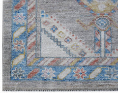 A handwoven wool runner featuring a transitional Oushak pattern in blue, grey, and soft pastels.