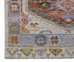 A handwoven transitional Oushak runner featuring a floral pattern in soft, contemporary colors.