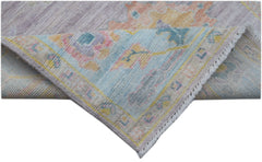A handmade Afghan Oushak runner featuring a traditional pattern in soft pastel tones.