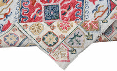 A handwoven transitional Oushak runner featuring a colorful floral pattern on a cream background.