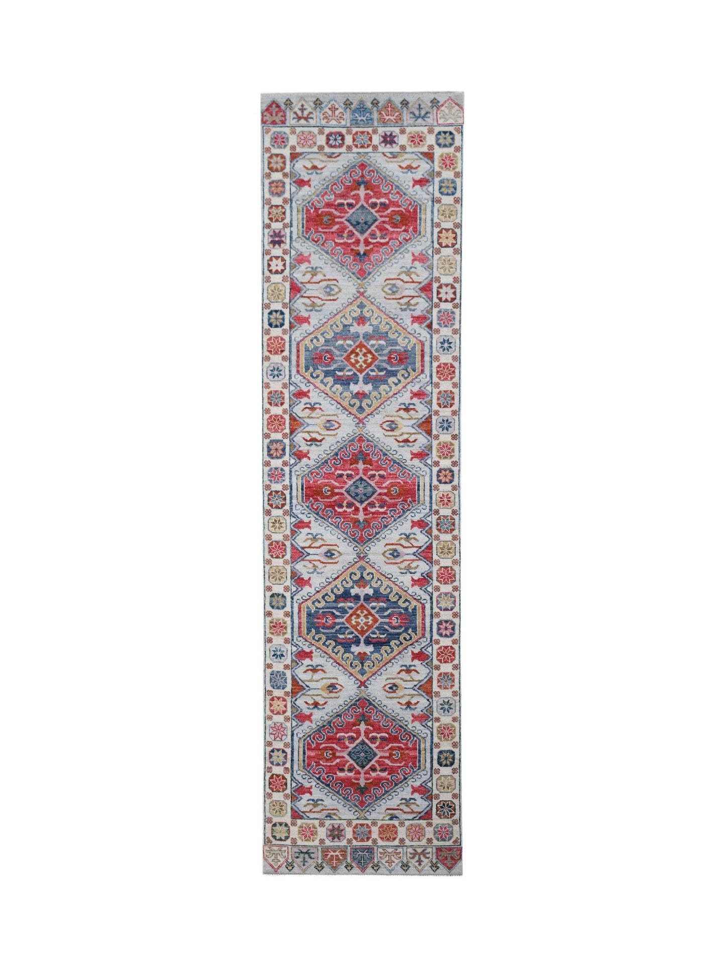 A handwoven transitional Oushak runner featuring a repeating geometric pattern in red and blue.