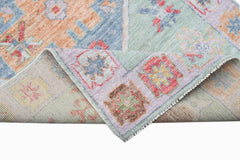 A handwoven transitional Oushak runner featuring a colorful floral pattern on wool.