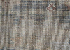 A handwoven transitional Oushak runner featuring a muted floral pattern in wool.