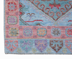 A handwoven transitional Oushak runner featuring a light blue field with colorful floral motifs.