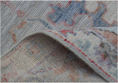 A close-up of a handmade wool Oushak runner featuring a traditional pattern in soft pastel tones.