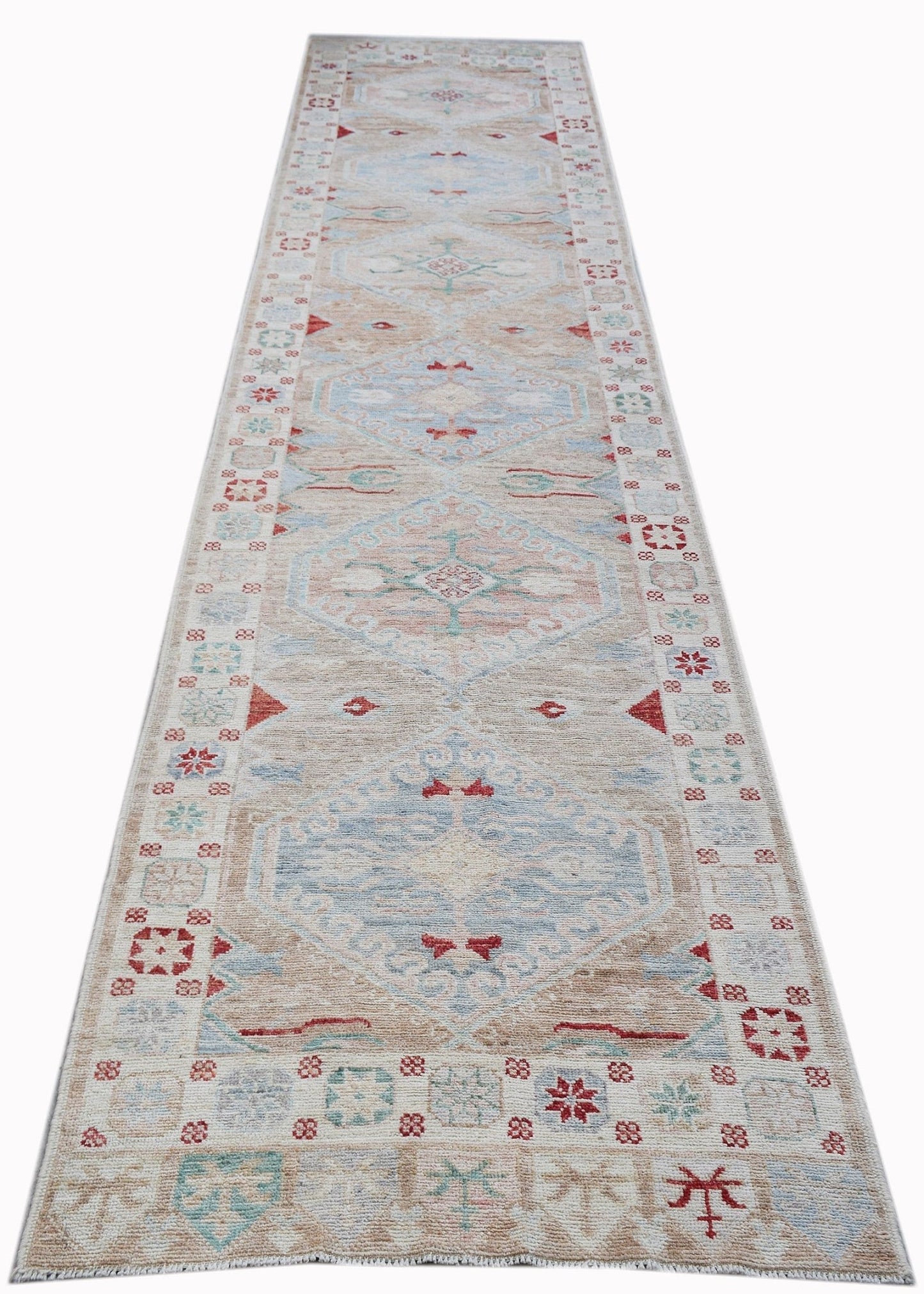 A handwoven transitional Oushak runner featuring a light beige field with blue and red motifs.