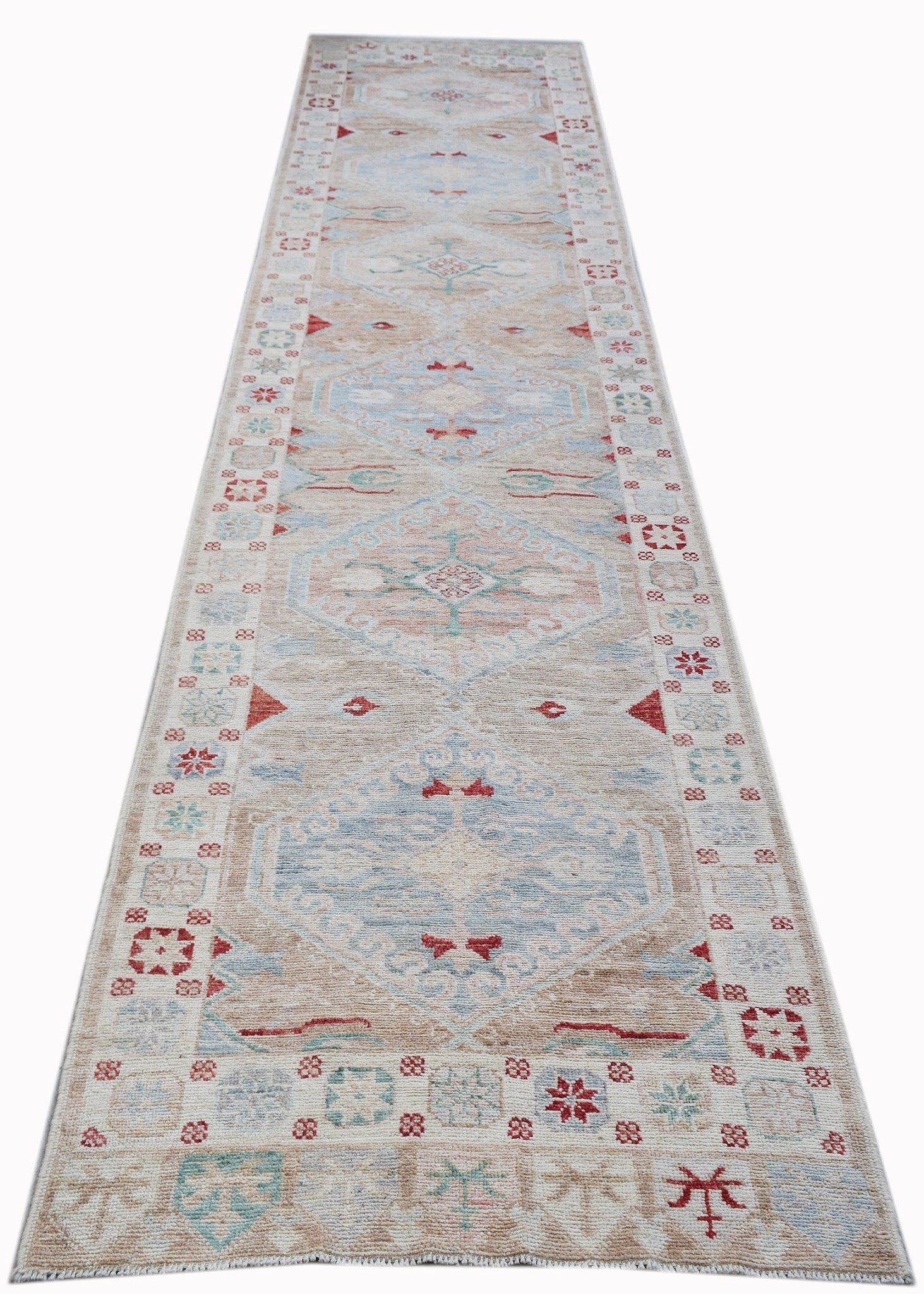 A handwoven transitional Oushak runner featuring a light beige field with blue and red motifs.
