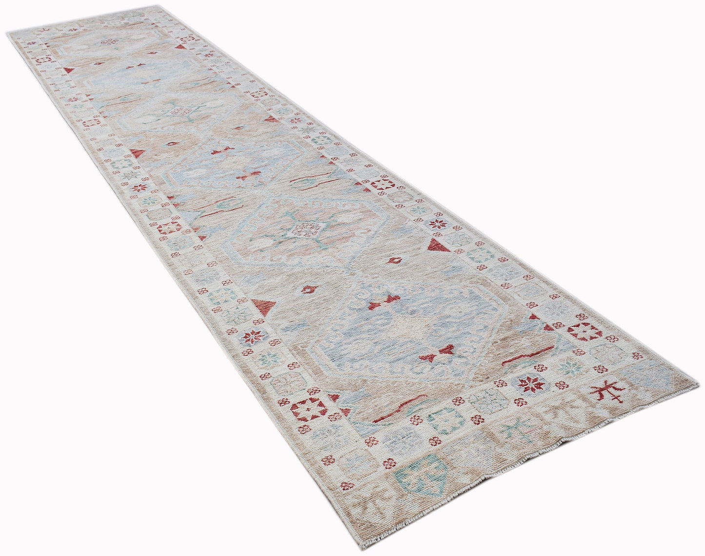 A long, handwoven wool runner rug featuring a transitional Oushak pattern in soft, muted tones.