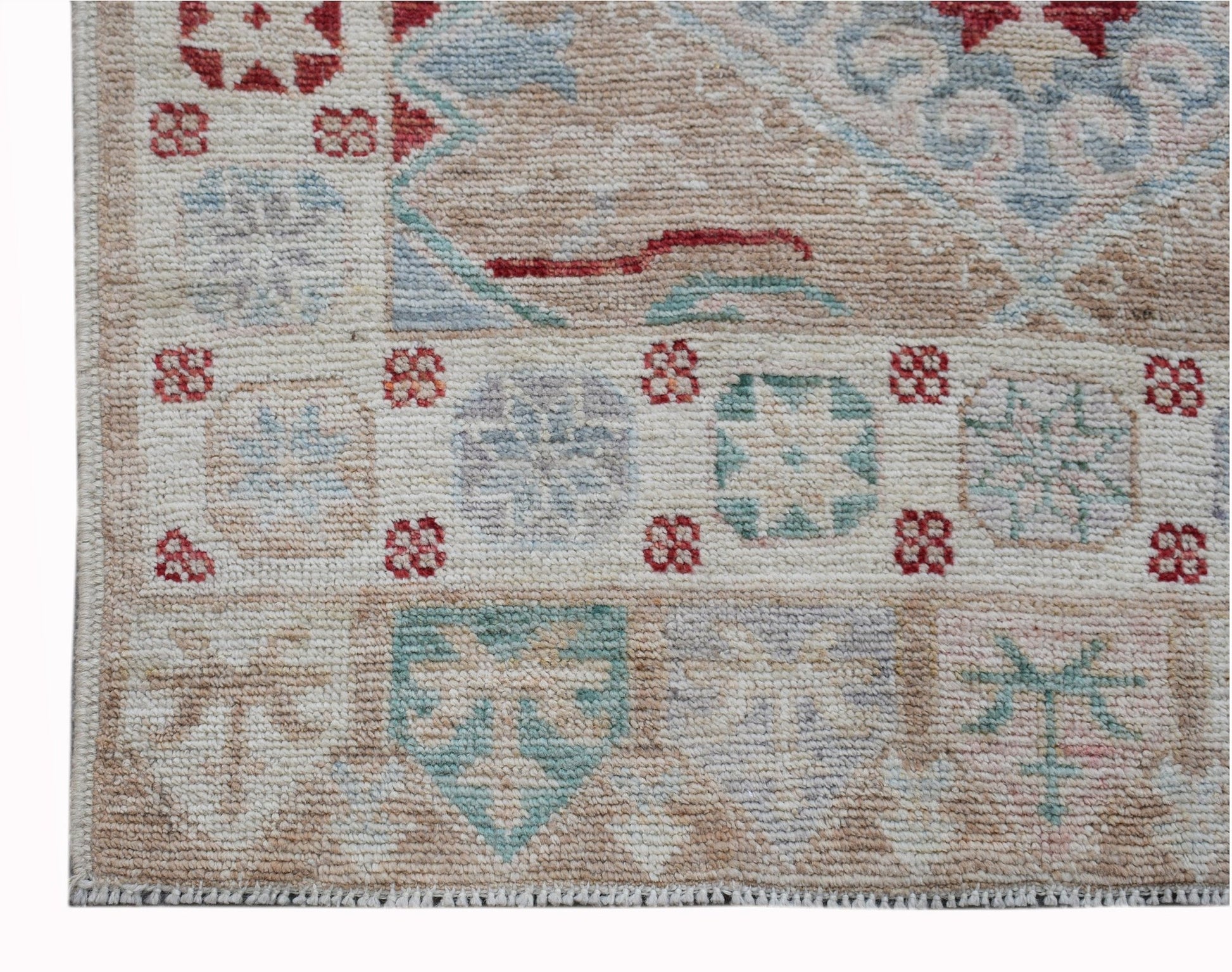 A handwoven transitional Oushak runner featuring a geometric floral pattern in muted tones.