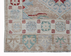 A handwoven transitional Oushak runner featuring a geometric floral pattern in muted tones.