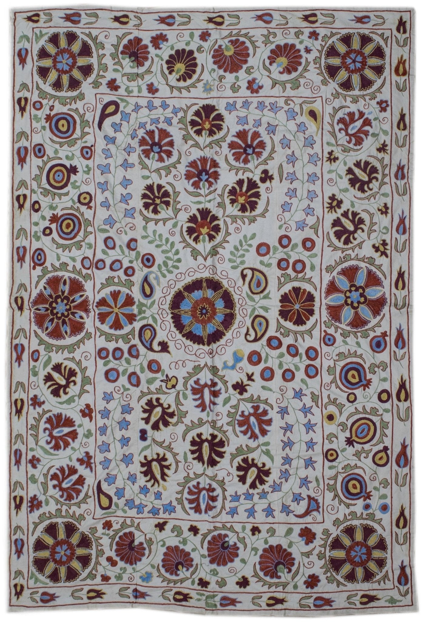 Handmade Uzbek suzani featuring intricate floral and botanical embroidery on a cotton base.