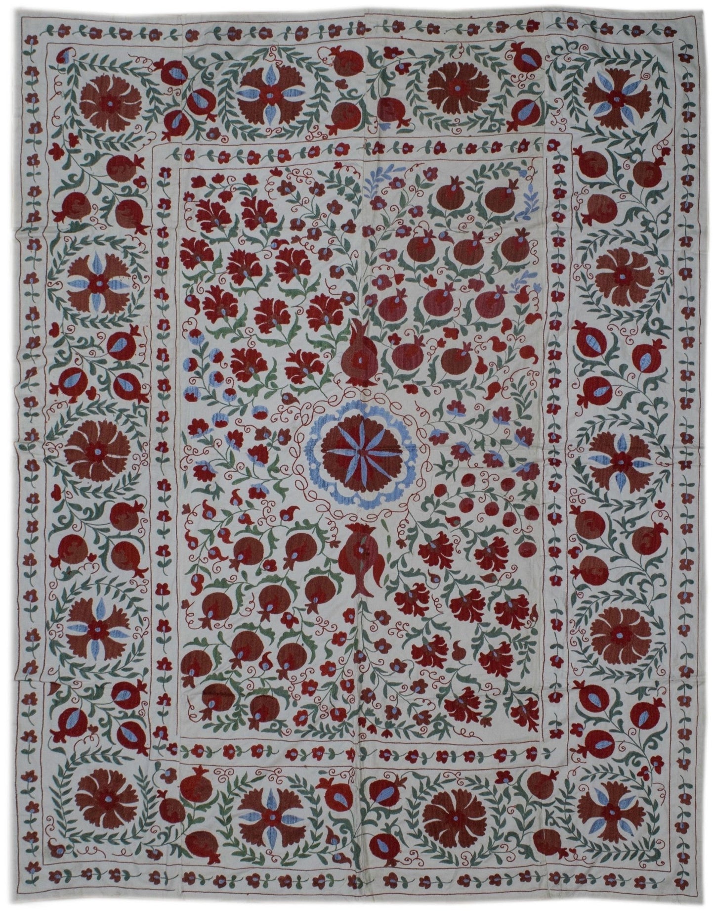 Handmade Uzbek suzani featuring intricate floral and pomegranate embroidery on a cotton base.