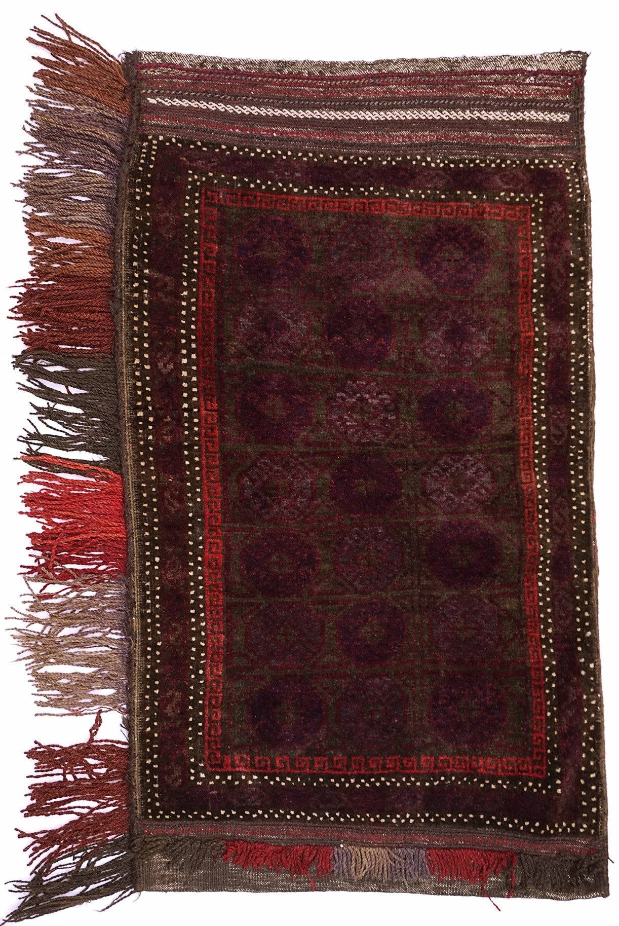 A handmade vintage Afghan Baluch wool cushion featuring a dark red geometric pattern and fringe.