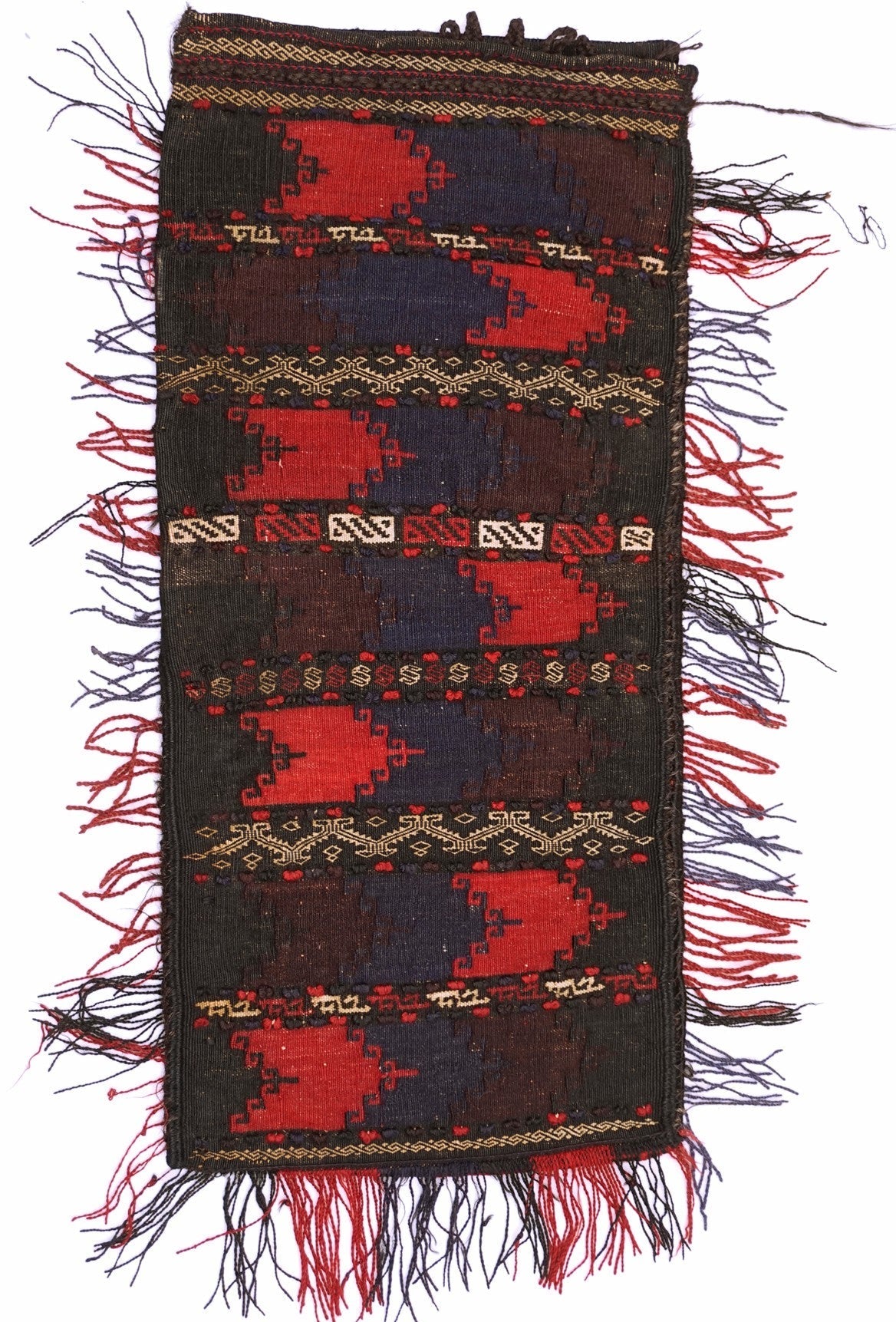 A vintage handmade Afghan Baluch wool cushion featuring geometric red and blue tribal patterns.