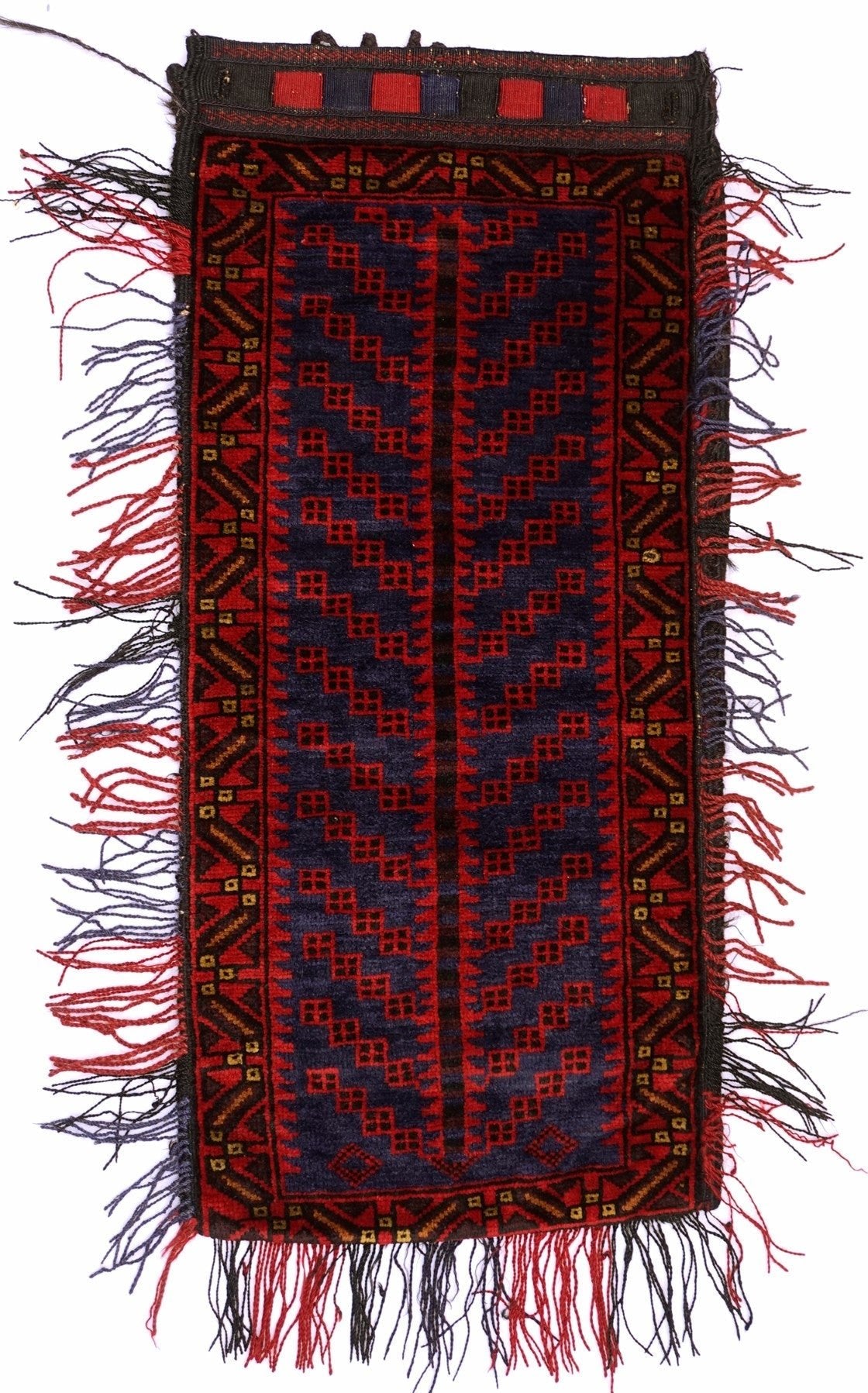 A vintage handmade Afghan Baluch wool cushion featuring a geometric red and blue tribal pattern.