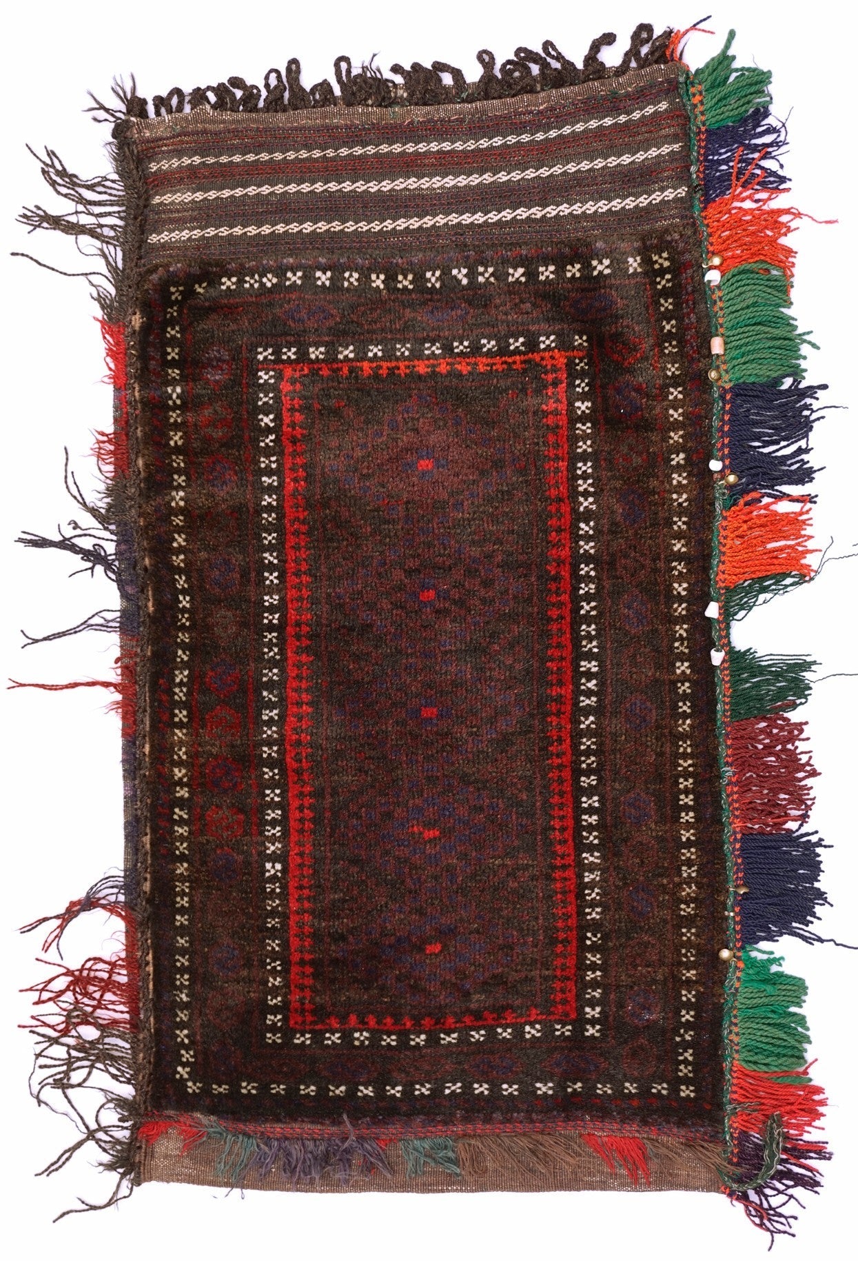 A handmade vintage Afghan Baluch wool cushion featuring a dark geometric pattern and side tassels.