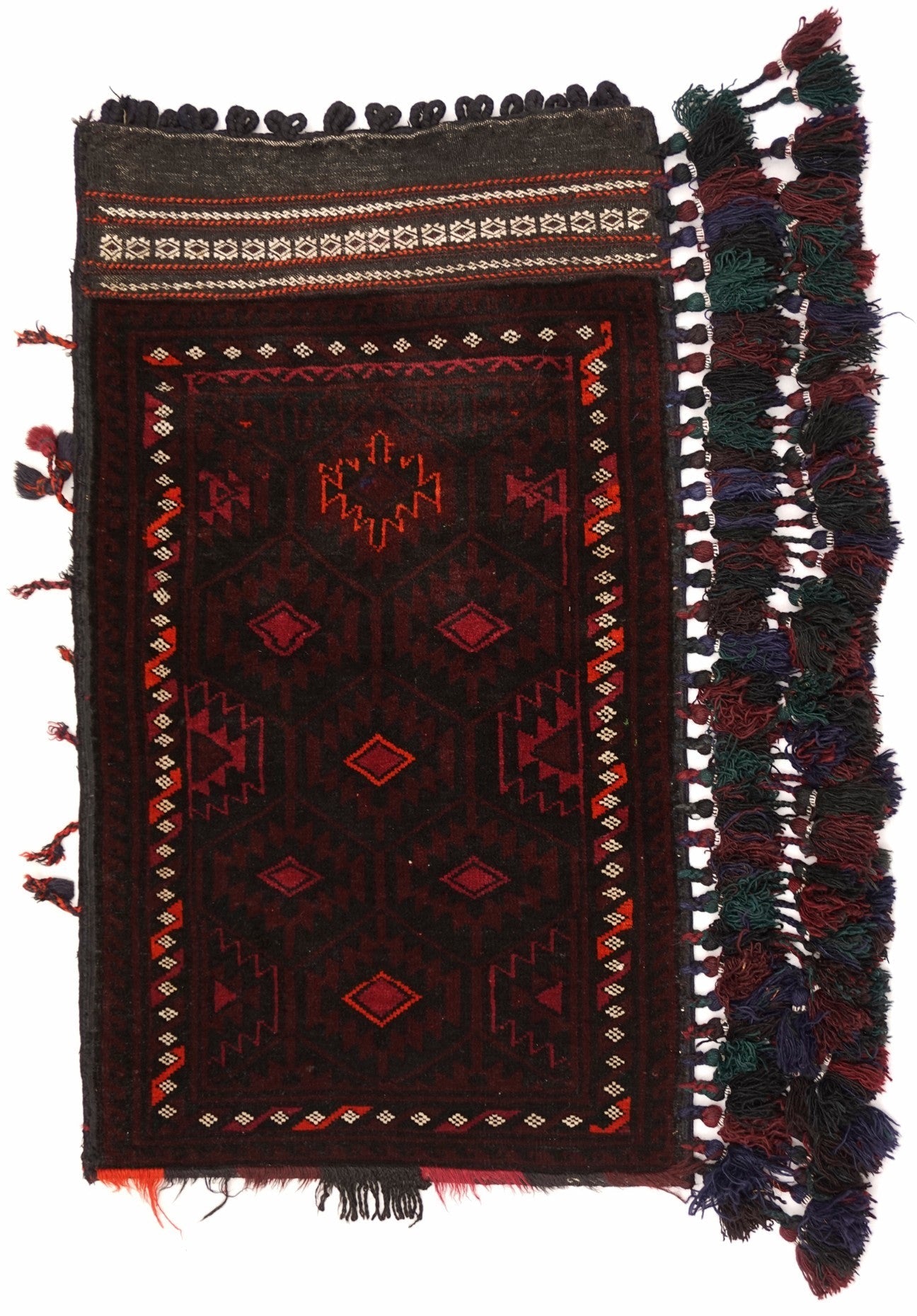 A handmade vintage Afghan Baluch wool cushion featuring dark red geometric patterns and tassels.