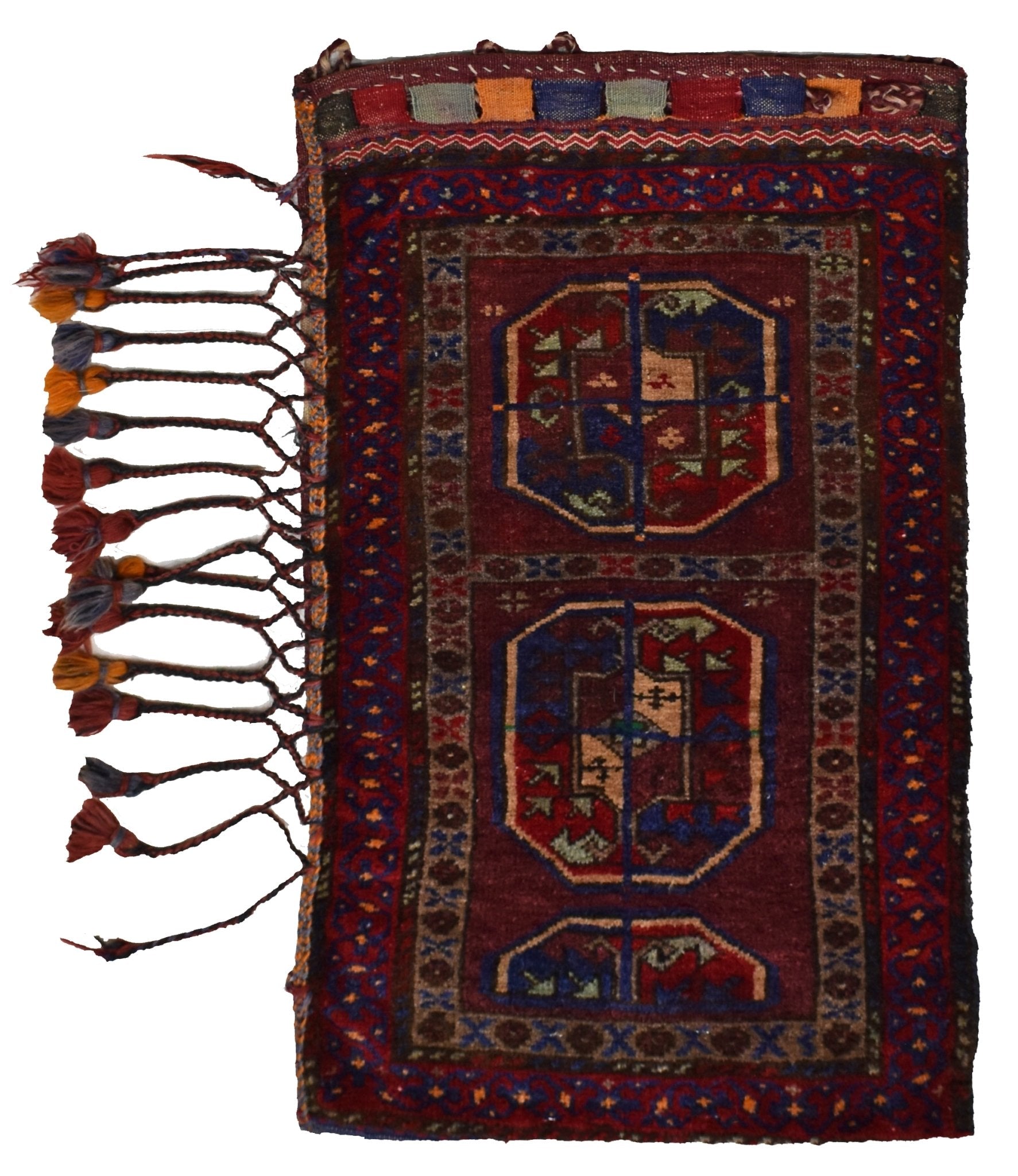 A vintage handmade Afghan Baluch wool cushion featuring two octagonal motifs and side tassels.