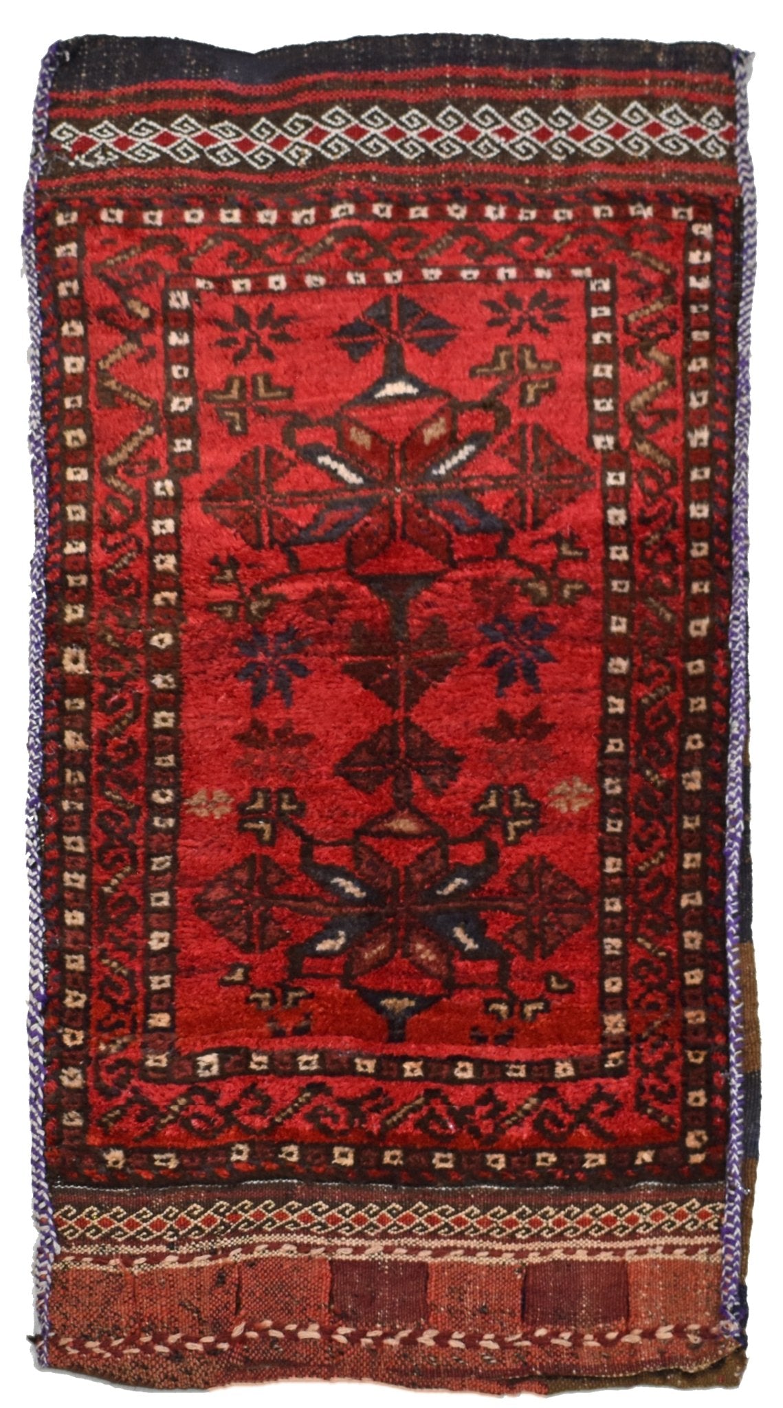 A vintage handmade Afghan Baluch wool cushion featuring a red field with geometric tribal motifs.