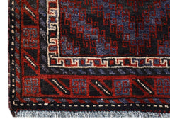 A vintage Afghan Baluch rug featuring geometric patterns in dark red, blue, and ivory wool.