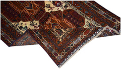 A vintage handmade Afghan Baluch rug featuring intricate geometric patterns in deep red and brown.