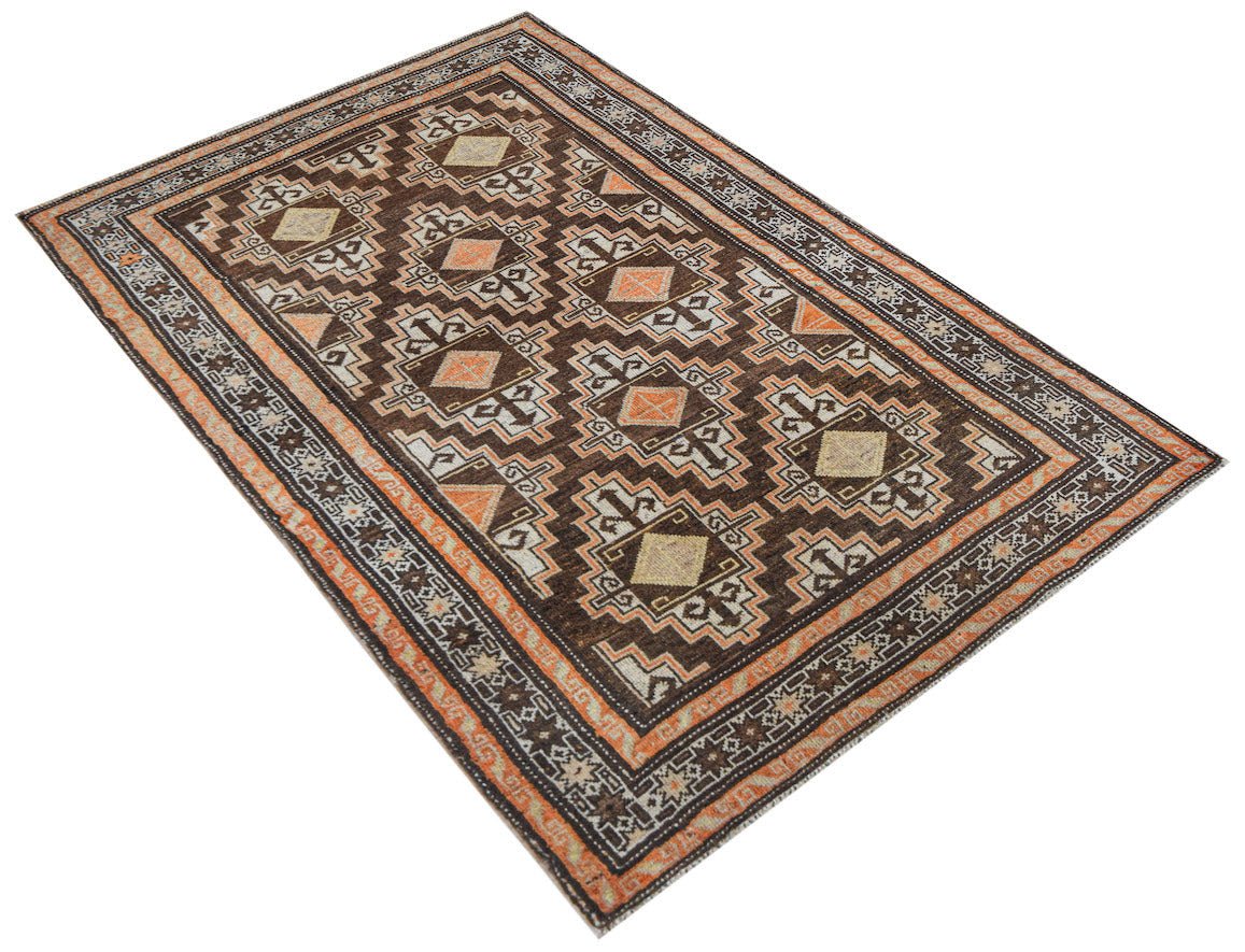 Vintage Afghan Baluch rug with geometric patterns in brown, orange, and cream.