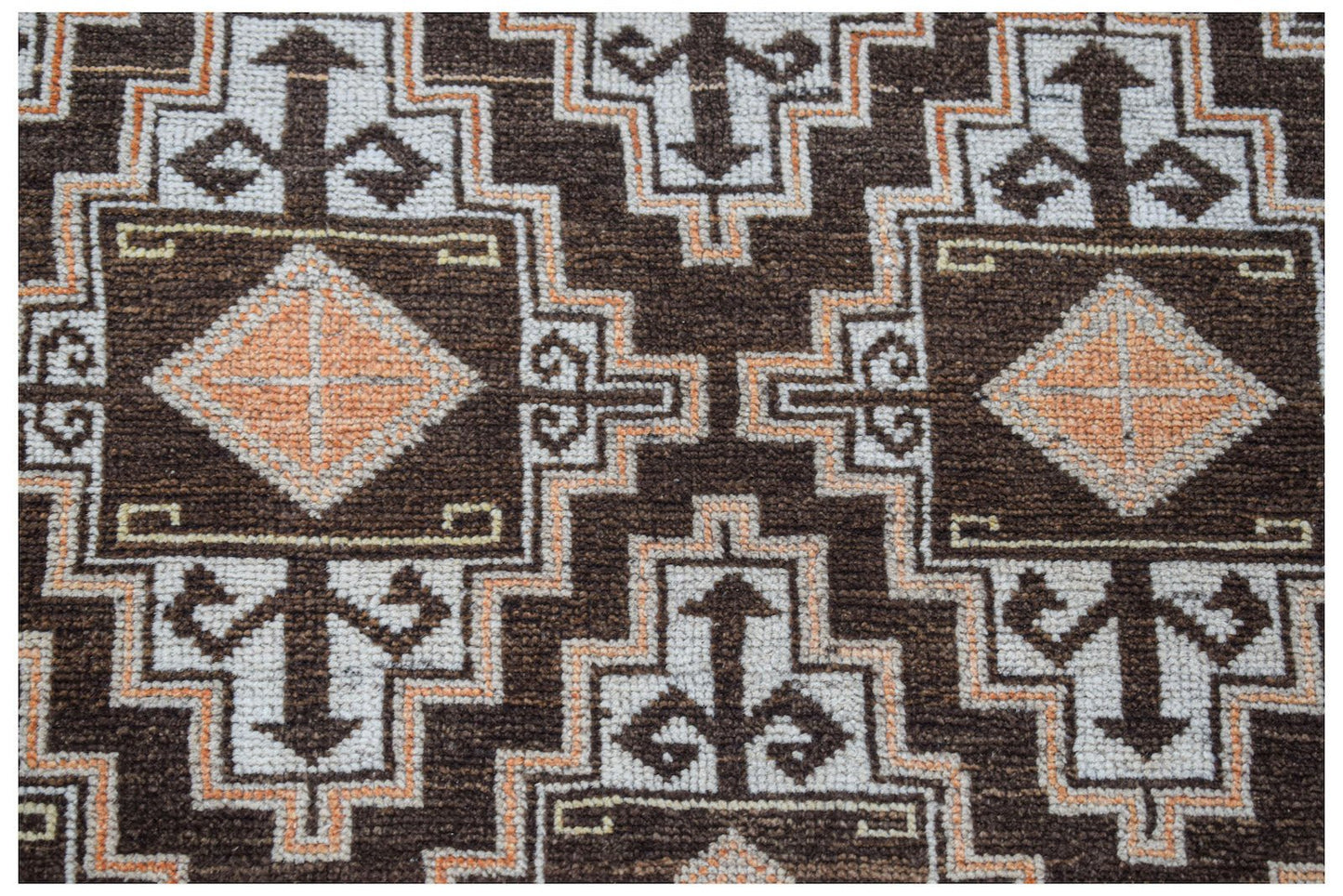 Vintage Afghan Baluch rug with geometric patterns in brown, white, and orange.