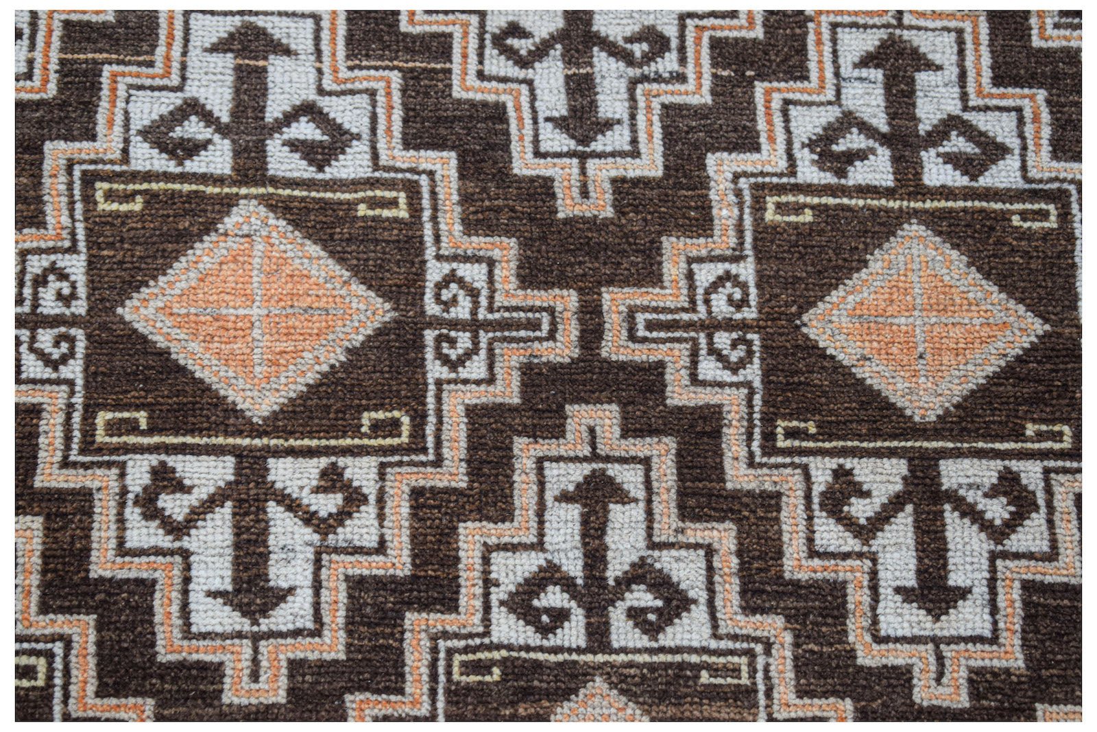 Vintage Afghan Baluch rug with geometric patterns in brown, white, and orange.