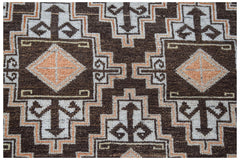 Vintage Afghan Baluch rug with geometric patterns in brown, white, and orange.