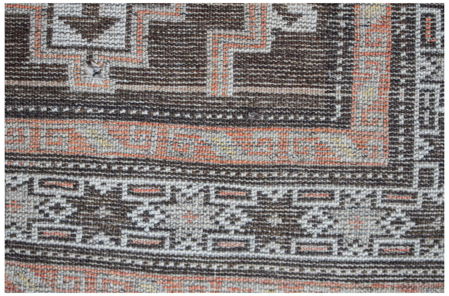 Vintage Afghan Baluch rug with geometric patterns in brown, orange, and cream.