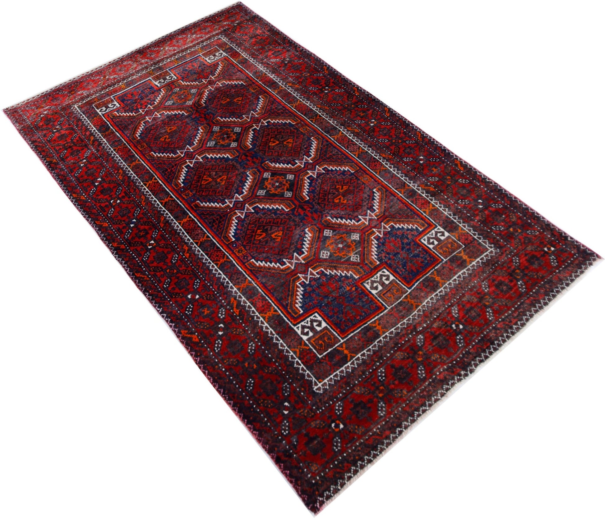 A handmade vintage Afghan Baluch rug featuring geometric patterns in deep red and blue tones.