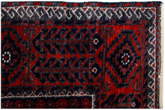 A vintage Afghan Baluch rug featuring traditional geometric patterns in red, black, and white.