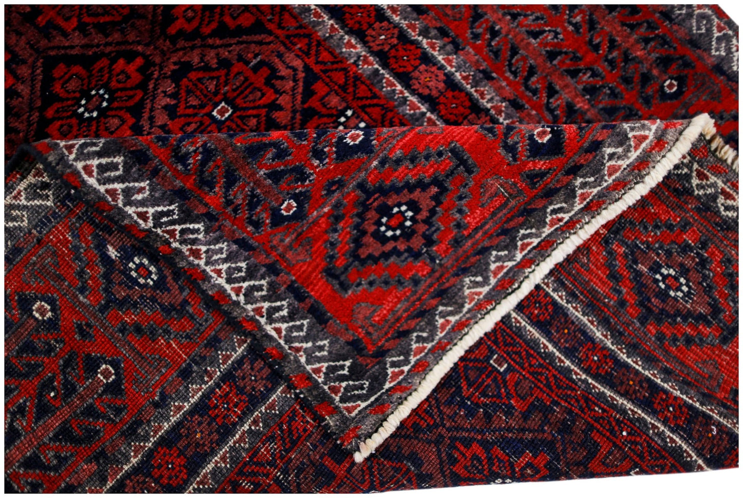 A handmade vintage Afghan Baluch rug featuring a geometric red and dark blue pattern.