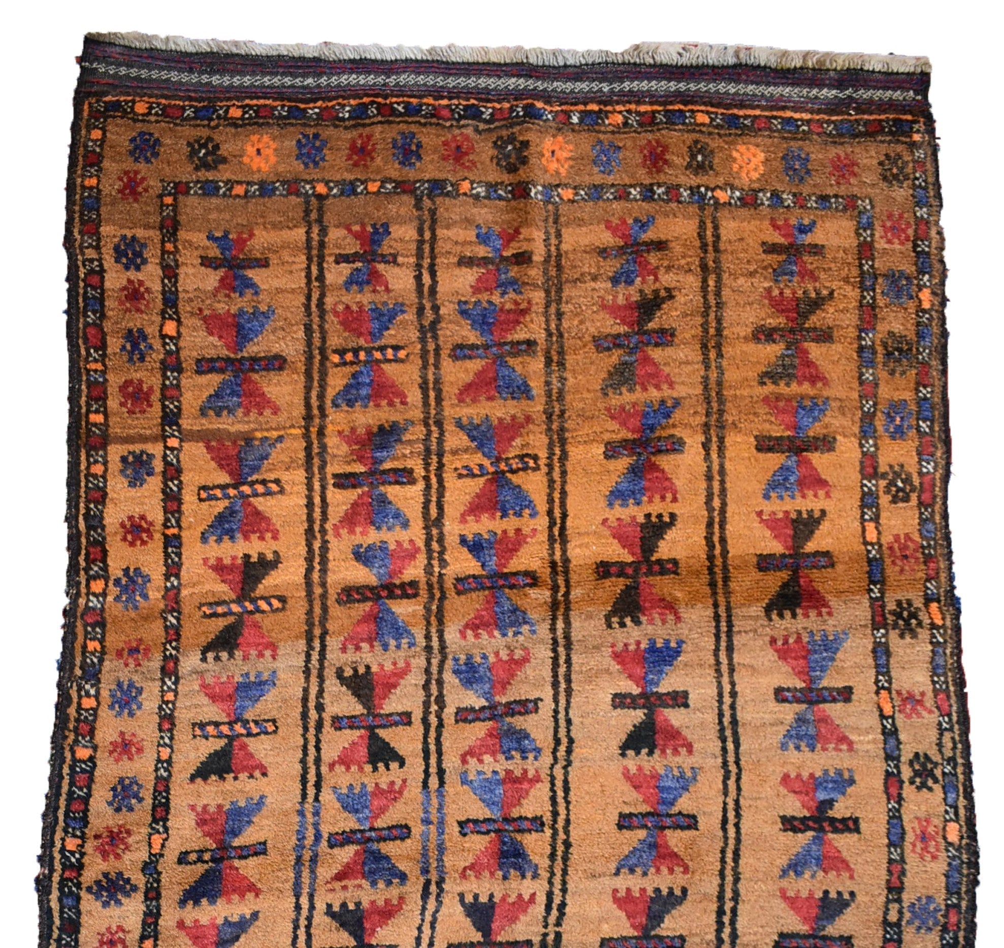 A vintage Afghan Baluch rug featuring repeating geometric motifs in blue and red on a tan field.