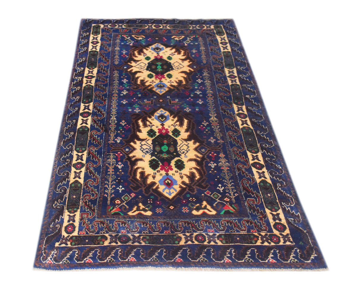 A vintage handmade Afghan Baluch rug featuring geometric patterns in blue, cream, and red wool.