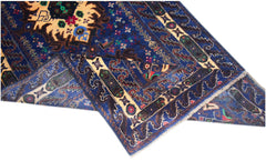 A vintage handmade Afghan Baluch rug featuring a deep blue field with intricate geometric patterns.